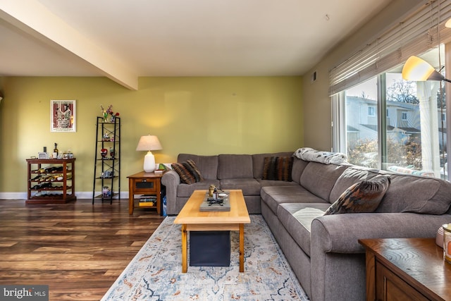 living room featuring beam ceiling and hardwood / wood-style floors