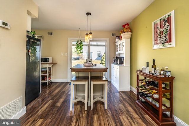 dining area with dark hardwood / wood-style flooring