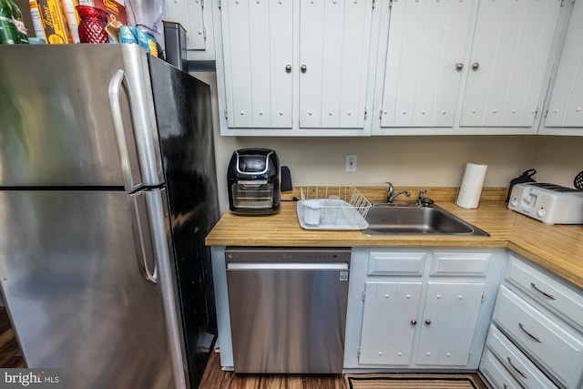 kitchen featuring white cabinetry, stainless steel appliances, and sink