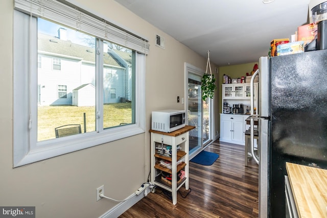 kitchen featuring dark hardwood / wood-style flooring and stainless steel refrigerator