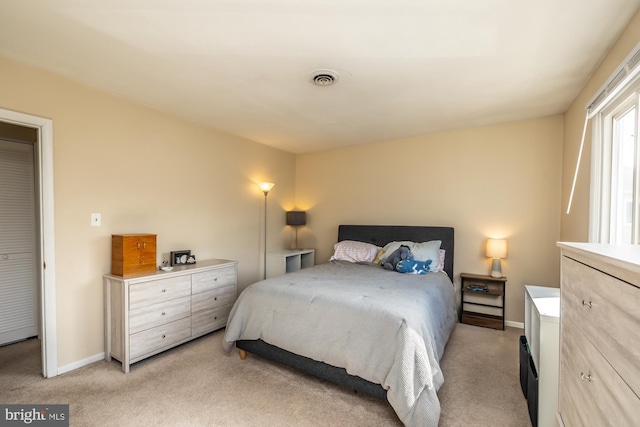 bedroom featuring light carpet