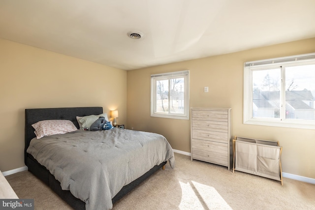 bedroom featuring light colored carpet