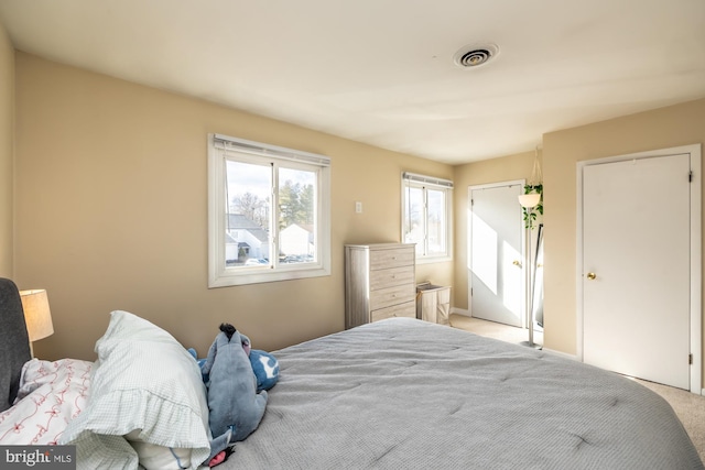 bedroom with light colored carpet