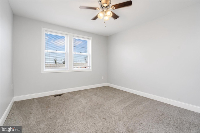 spare room with ceiling fan and carpet floors