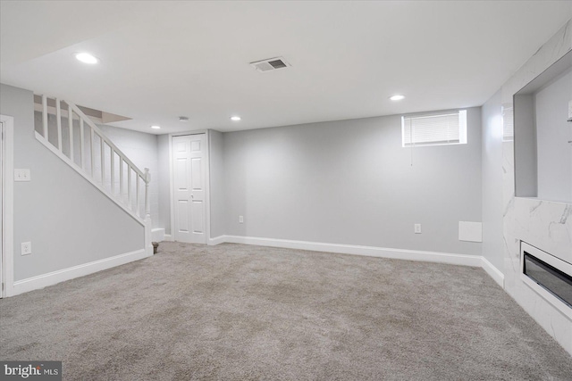 basement featuring a fireplace and carpet flooring