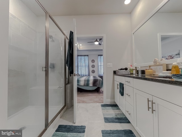 bathroom featuring vanity and a shower with door