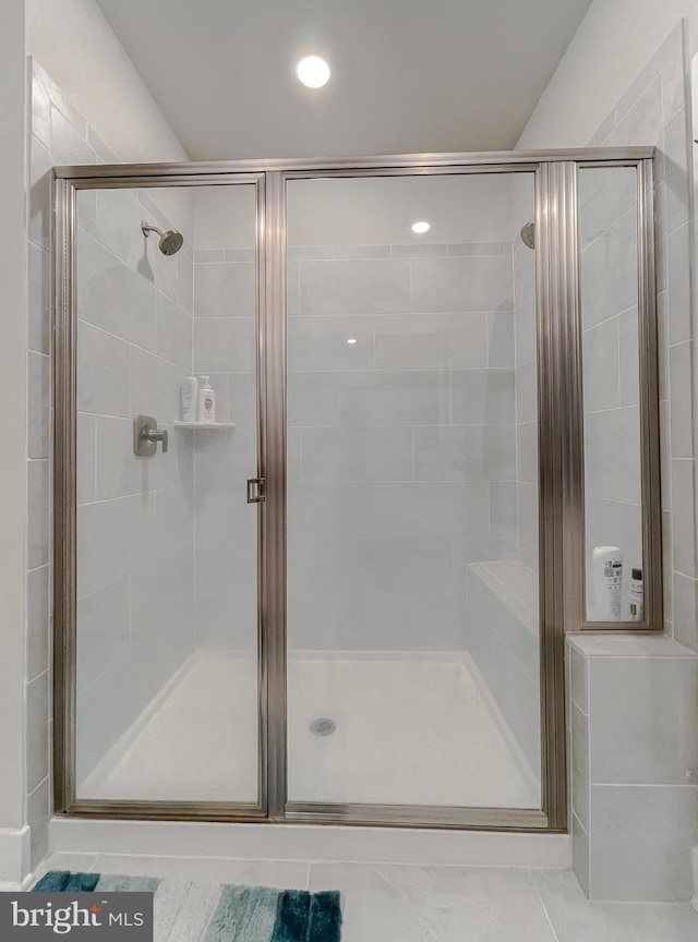 bathroom with a shower with door