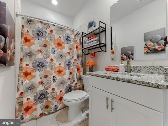 bathroom featuring vanity, tile patterned floors, and toilet