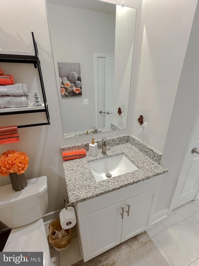 bathroom with tile patterned floors, toilet, and vanity