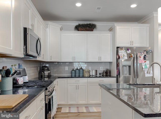 kitchen with white cabinetry and stainless steel appliances