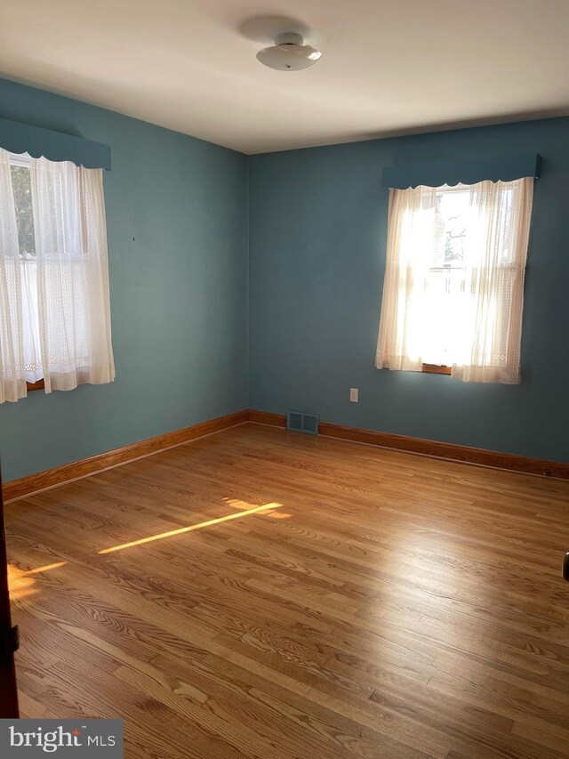 spare room with hardwood / wood-style floors