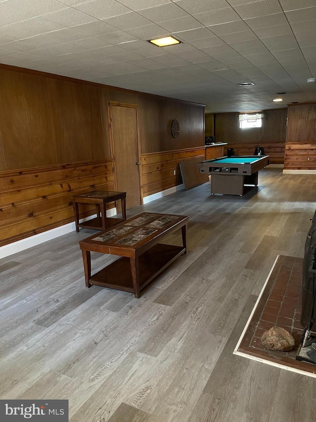 playroom with light hardwood / wood-style flooring, billiards, and wooden walls