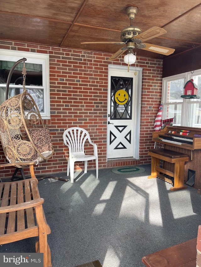 doorway to property featuring ceiling fan