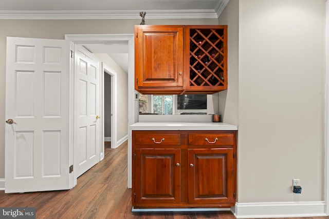 kitchen featuring crown molding and dark hardwood / wood-style flooring