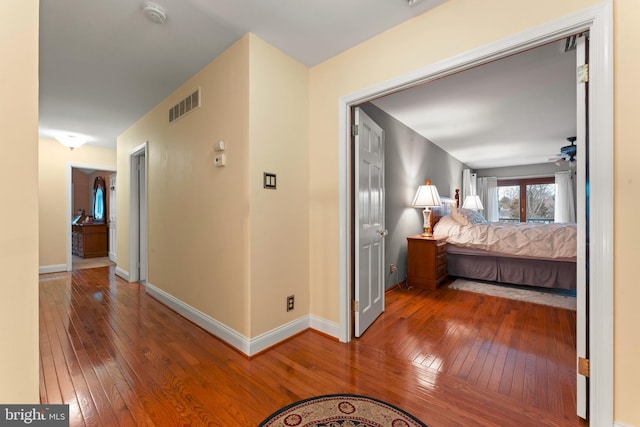 hallway with hardwood / wood-style flooring