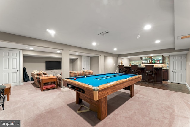 rec room featuring light carpet, bar, and billiards