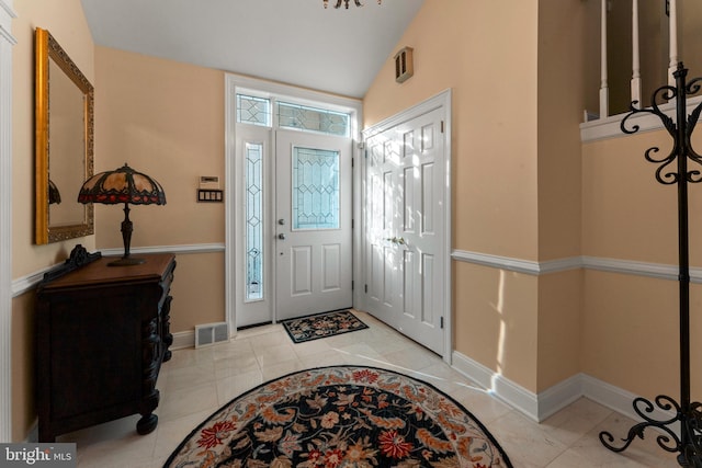 tiled entrance foyer with vaulted ceiling