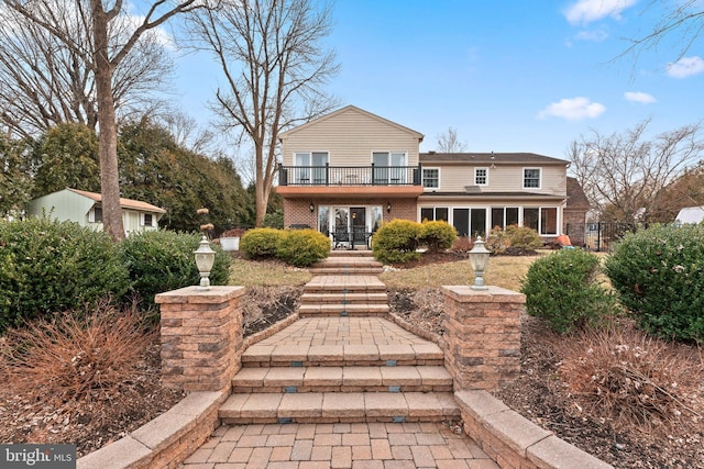 rear view of house featuring a balcony