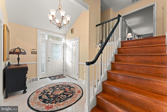 entryway with a chandelier, vaulted ceiling, and light tile patterned floors