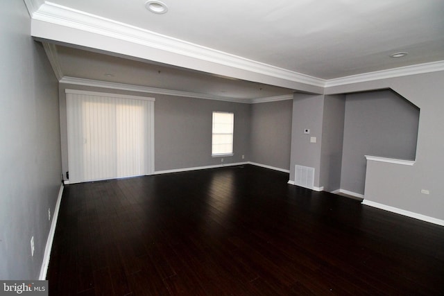 spare room with crown molding and dark wood-type flooring