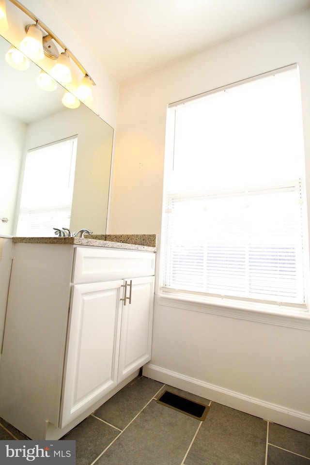 bathroom with vanity and tile patterned flooring