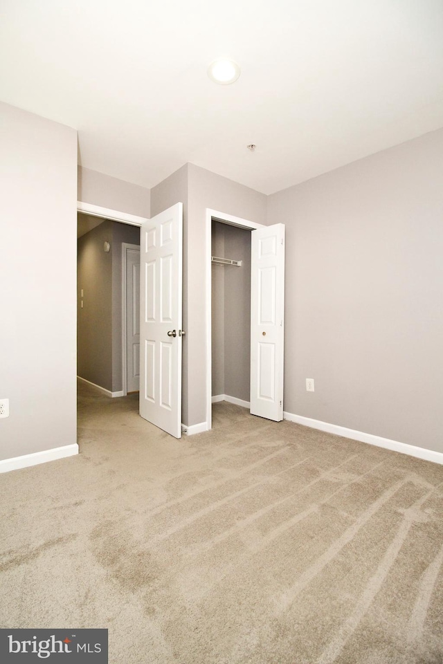 unfurnished bedroom featuring carpet floors and a closet