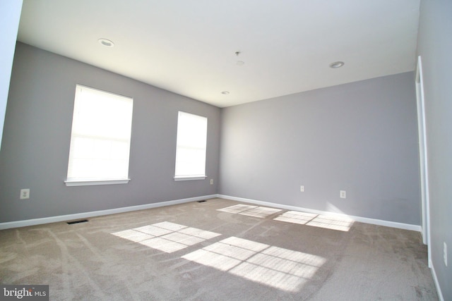 empty room with light colored carpet