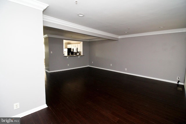 unfurnished room with ornamental molding and dark hardwood / wood-style floors