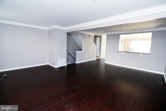 unfurnished living room featuring wood-type flooring and ornamental molding