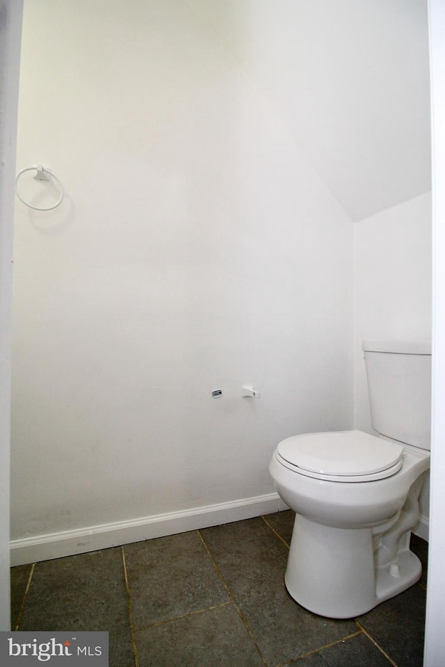 bathroom featuring vaulted ceiling and toilet