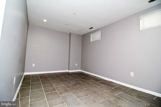 unfurnished room with dark tile patterned floors