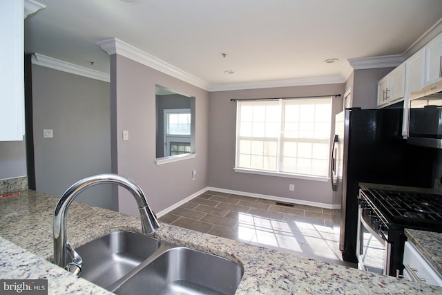 kitchen featuring sink, crown molding, appliances with stainless steel finishes, light stone counters, and white cabinets