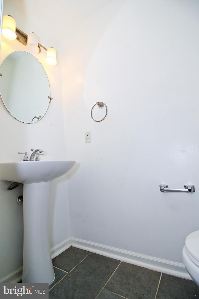 bathroom with tile patterned floors and toilet