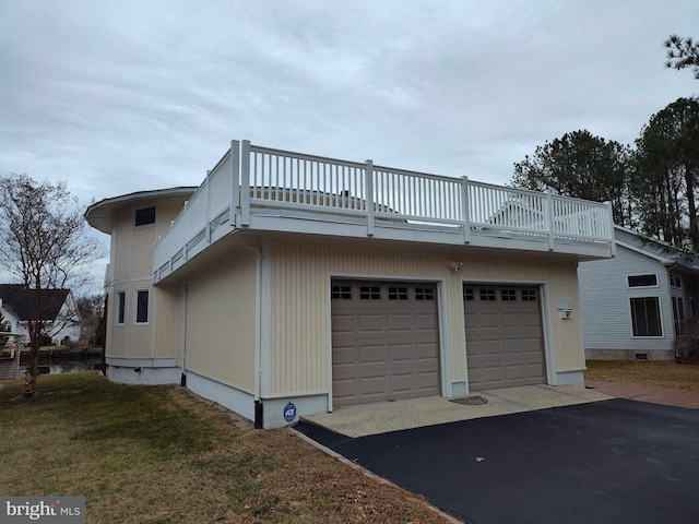 view of home's exterior with a garage and a yard