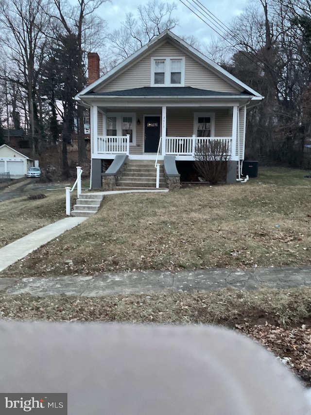 bungalow-style home with central AC unit and covered porch