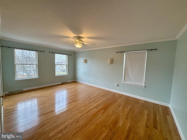 spare room featuring ornamental molding, ceiling fan, and light wood-type flooring