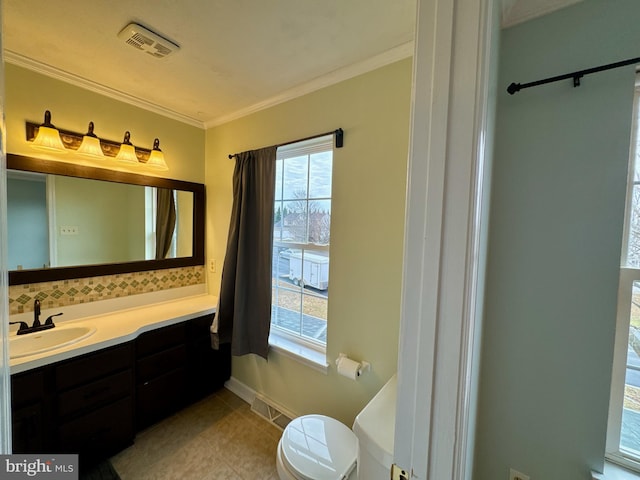 bathroom with vanity, tile patterned floors, ornamental molding, and toilet