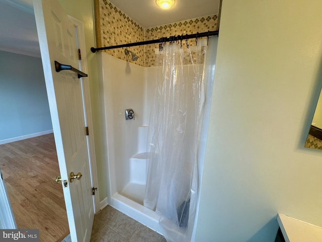 bathroom featuring a shower with curtain and ornamental molding