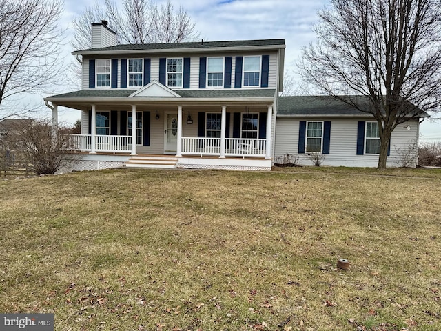 colonial house featuring a porch and a front yard