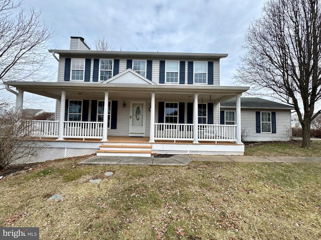 view of front facade featuring a front yard and a porch