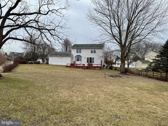 rear view of property featuring a yard