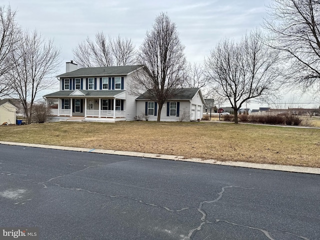 view of front facade featuring a front yard and covered porch