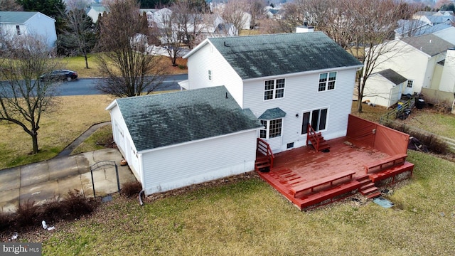 rear view of property with a yard and a deck