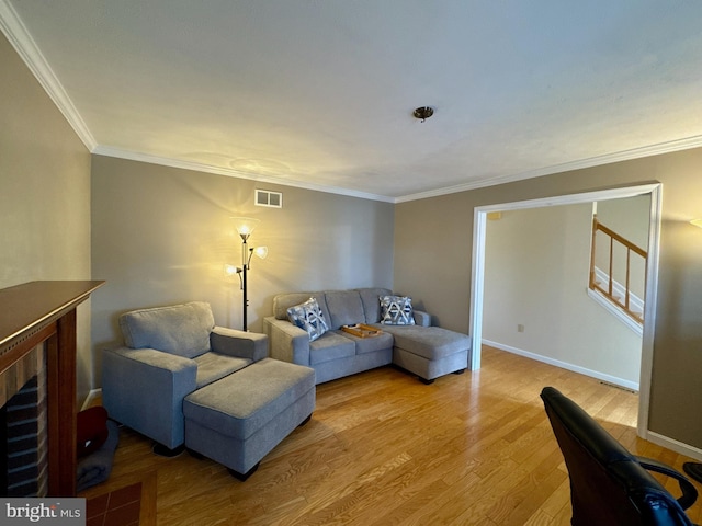 living room with crown molding and light wood-type flooring