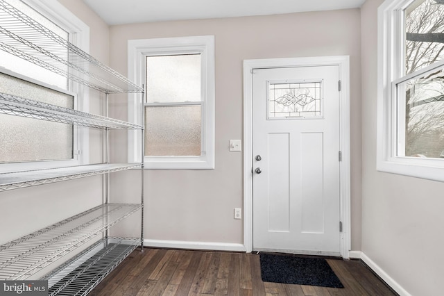 entryway with baseboards and dark wood finished floors