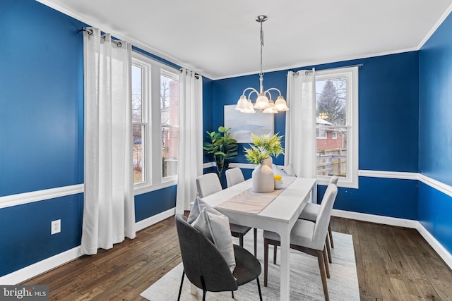 dining space featuring dark wood-style floors, a healthy amount of sunlight, and a notable chandelier