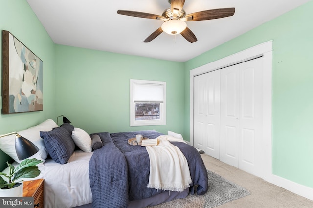 bedroom featuring carpet flooring, baseboards, a ceiling fan, and a closet