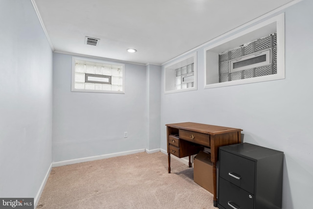 office area featuring light carpet, baseboards, visible vents, and ornamental molding