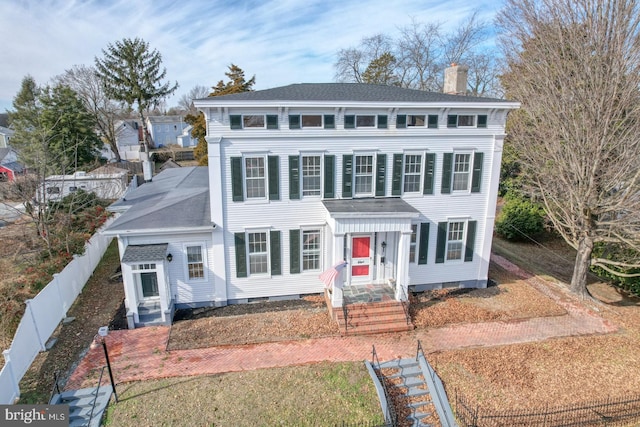 colonial home with a front lawn