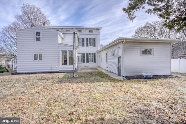 rear view of house with a yard